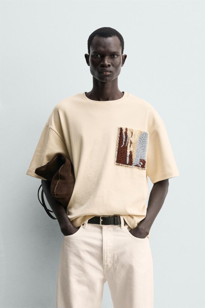 Beige t-shirt featuring abstract textured textile artwork on chest pocket placement for Zara Man.